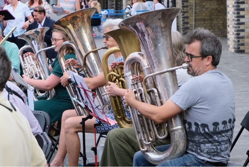 4 people playing tubas